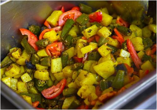 a stir fry with vegetables in a pan at AYM Yoga Resort Arambol GOA in Arambol
