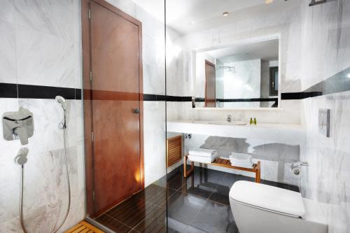 a bathroom with a toilet and a sink and a mirror at Anna's House in Georgioupolis