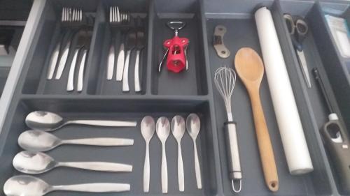 a drawer filled with utensils and spoons at Jacuzzi Romantique 15 min Etretat 1 in Fécamp