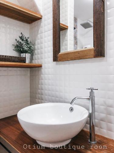 a white bathroom with a sink and a mirror at Otium Boutique Room in Pai