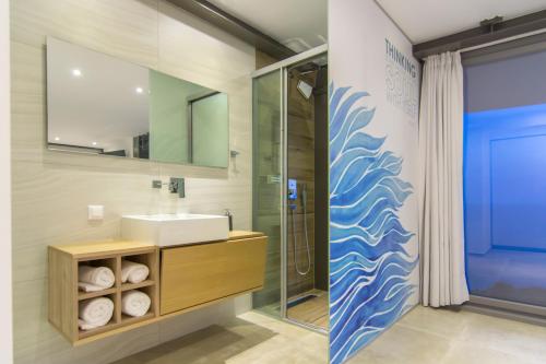 a bathroom with a sink and a shower at Luxury Glass Villas in Syvota