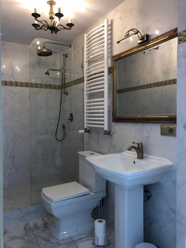 a bathroom with a sink and a toilet and a shower at APARTAMENT 6 Rynek in Wrocław