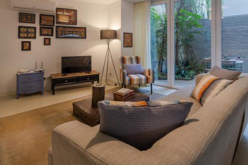 a living room with a couch and a television at My Suite Lisbon Serviced Apartments - Principe Real in Lisbon