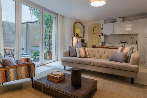a living room with a couch and a table at My Suite Lisbon Serviced Apartments - Principe Real in Lisbon