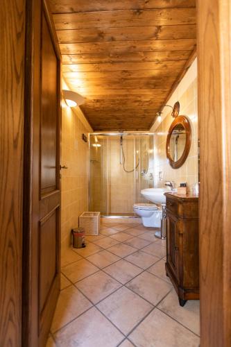 a bathroom with a toilet and a sink and a mirror at Palazzo Lauritano in Agerola