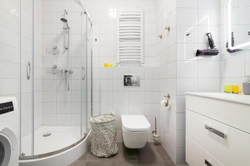 a bathroom with a shower and a toilet and a sink at Royal Palace Elegant Apartment in Warsaw