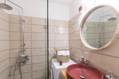 a bathroom with a red sink and a mirror at Stylish, comfy apartment by Konnect, Corfu city center in Corfu