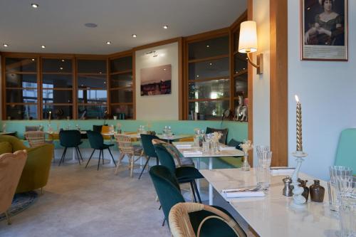 a restaurant with a long table and chairs at Best Western Plus Paris Saclay in Saclay