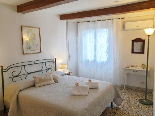 a bedroom with a bed with two towels on it at RistoriApartment in Florence