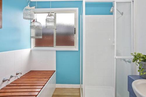 a bathroom with a bench next to a window at SEAVIEW - ocean views from a modern townhouse in Apollo Bay