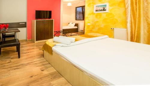 a hotel room with a bed and a desk with a desk at Hotel EOS in Bucharest