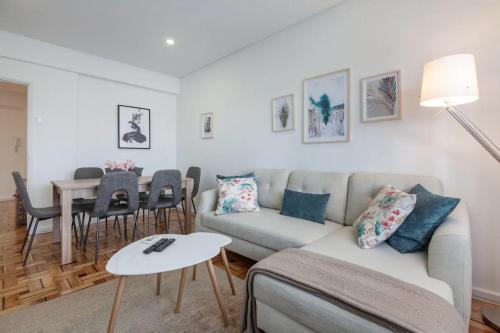 a living room with a couch and a table at Old Market Apartment in Guimarães