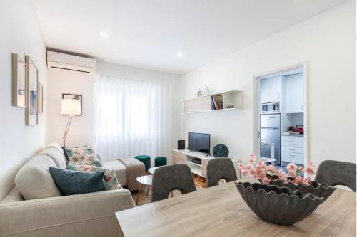 a living room with a couch and a table at Old Market Apartment in Guimarães