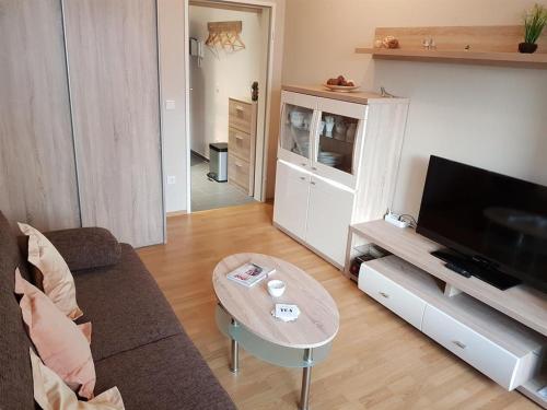 a living room with a couch and a coffee table at Haus Seelord am Weststrand in Norderney