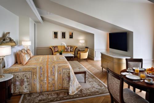 a bedroom with a bed and a living room at Palazzo Versace Dubai in Dubai