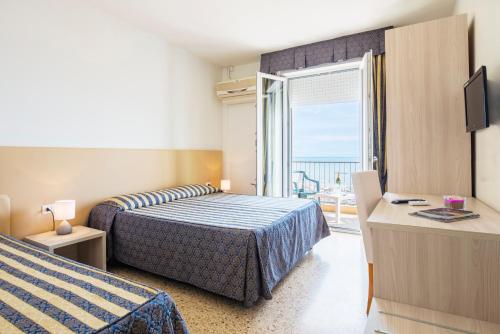 Postel nebo postele na pokoji v ubytování Hotel Columbus