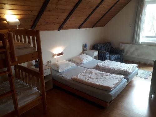Postel nebo postele na pokoji v ubytování Vakantiehuis Reuzengebergte