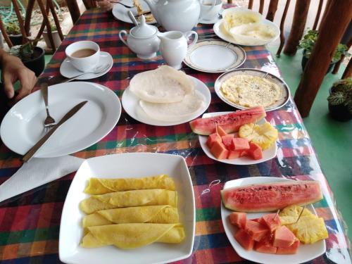 a table with plates of food on a table at Astral Zone Cottage ELLA in Ella