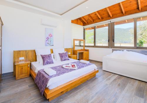 a bedroom with a large bed and a large window at Villa 3 Sleeps 4 Isolated Honeymoon-Villa Lale in Üzümlü
