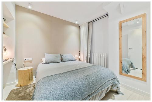 a bedroom with a bed and a large window at Apartamentos Madrid Rio in Madrid