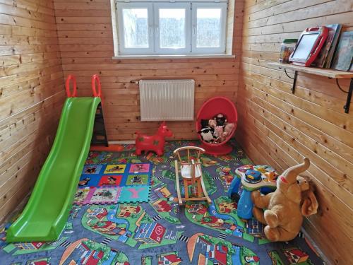 a childs room with a play area with a slide at Penzion Loučka Bystřice in Bystrzyca