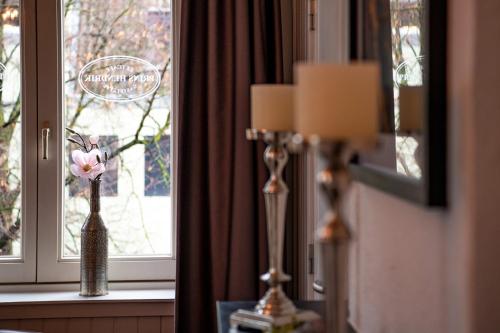 a window sill with a vase with flowers in it at BnB prins Hendrik Venlo in Venlo