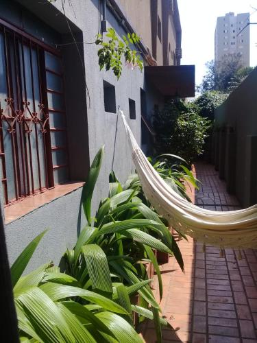 a hammock hanging from the side of a building at Pousada Dom Aquino in Campo Grande
