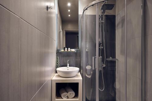 a bathroom with a sink and a shower at Ionian Hill Hotel in Argasi