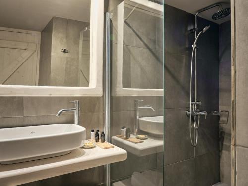 
a bathroom with a shower, sink, and tub at Ionian Hill Hotel in Argassi
