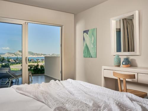 
a hotel room with a bed and a window at Ionian Hill Hotel in Argassi
