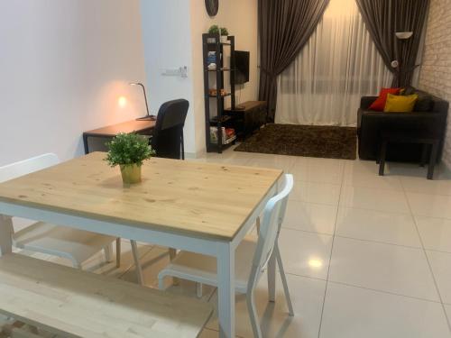 a dining table and chairs in a living room at Relaxed Family Staycation, Pool View w WIFI n Netflix in Bangi