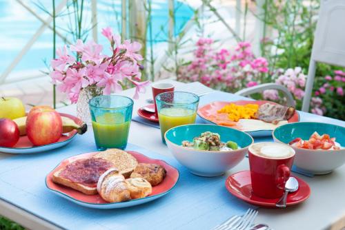 a table topped with plates of breakfast foods and drinks at Park Residence Il Gabbiano in Moniga