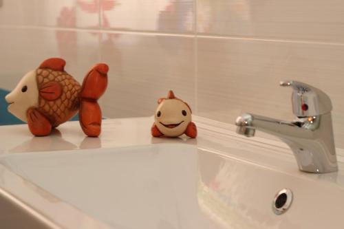 two stuffed animals sitting on top of a bathroom sink at Capo d'Orlando Apartments in Capo dʼOrlando