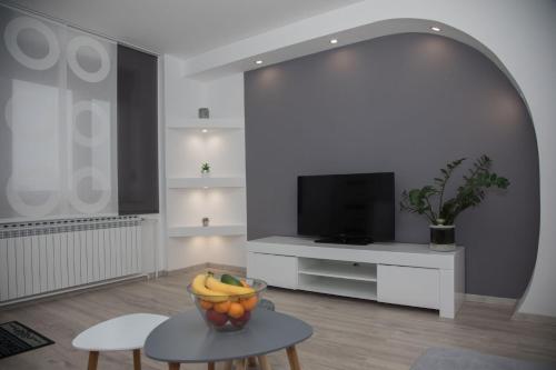 a living room with a bowl of fruit on a table at Apartman Coelum Delnice in Delnice