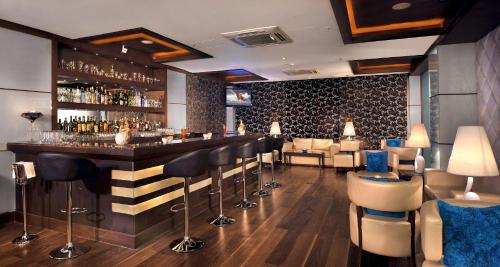 a bar in a restaurant with a lot of chairs at Country Inn & Suites by Radisson, Gurugram Sector 12 in Gurgaon
