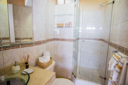 a bathroom with a shower and a toilet and a sink at Oceanfront Penthouse in Miraflores in Lima