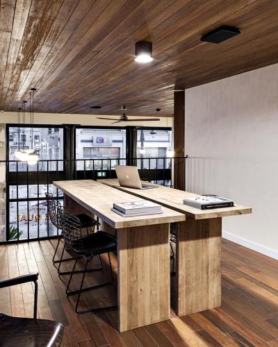 an office with a large wooden table with a laptop on it at New Hotel Le Quai - Vieux Port in Marseille