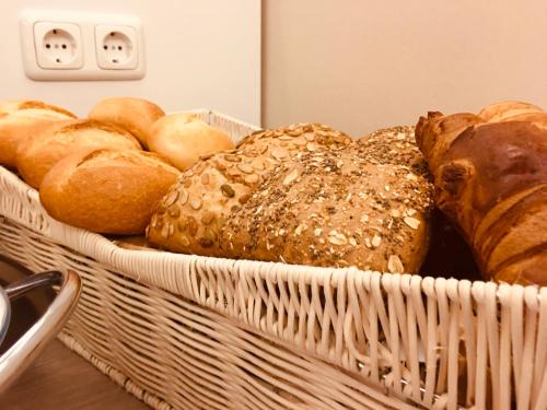 a basket filled with lots of different types of bread at Hotel Glinde in Hamburg