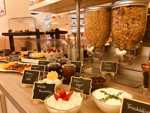 a buffet with bowls of food on a counter at Hotel Glinde in Hamburg