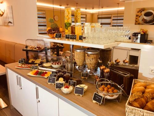 a buffet of food on a counter in a kitchen at Hotel Glinde in Hamburg