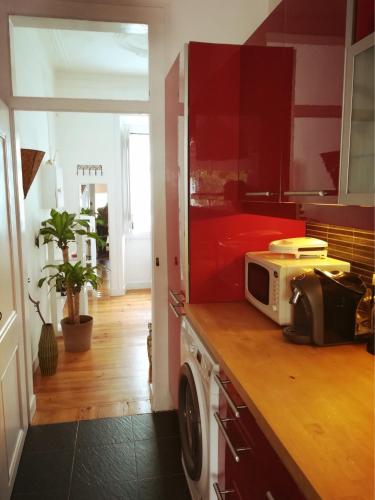 a kitchen with a microwave on top of a counter at Lovely Apartment near Belém in Lisbon