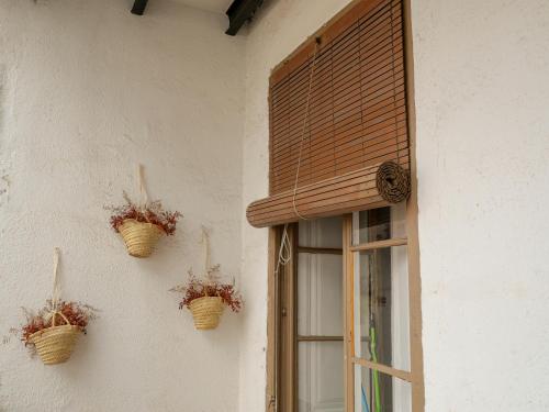 two baskets on the side of a building with a window at Luxury Apartment Stancesvic in Vic