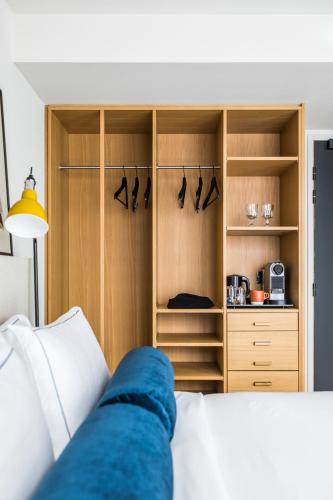 a bedroom with a bed and a closet at Le Grand Quartier in Paris