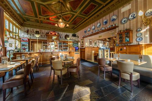 a restaurant with tables and chairs and plates on the walls at BnB prins Hendrik Venlo in Venlo