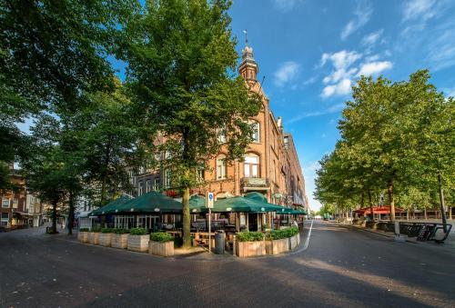 a building with a clock tower on a city street at BnB prins Hendrik Venlo in Venlo