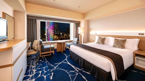a hotel room with a bed and a window at InterContinental Yokohama Grand by IHG in Yokohama
