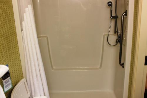 a shower door in a bathroom with a toilet at Holiday Inn Express Yorkton East, an IHG Hotel in Yorkton