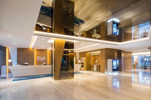 a lobby with a reception desk in a building at Holiday Inn Express Wuxi Taihu New City, an IHG Hotel in Wuxi