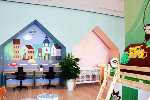 a childs room with a house mural on the wall at Holiday Inn Wuxi Taihu New City by IHG in Wuxi