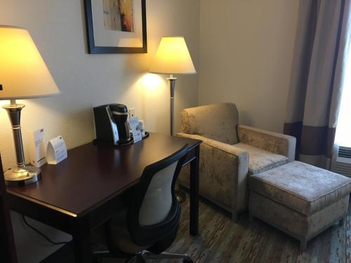 a hotel room with a desk and a chair at Holiday Inn Express West Jefferson by IHG in West Jefferson